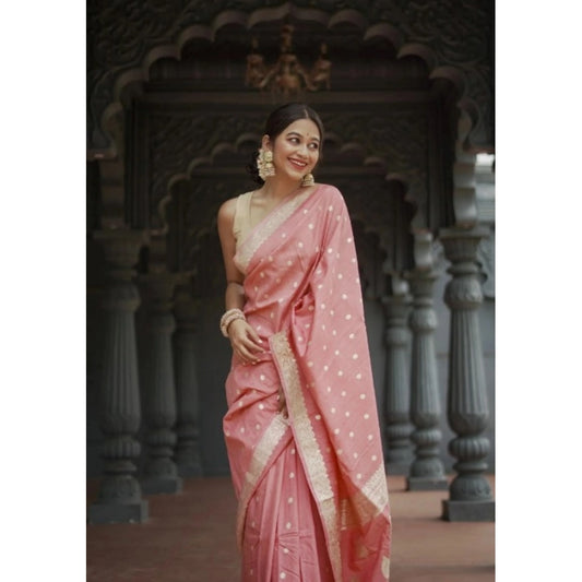 Woman in a pink saree with white polka dots