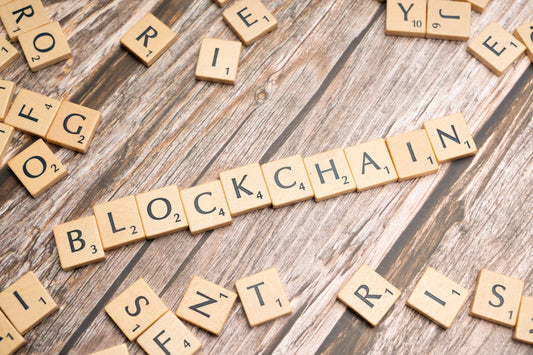 scrabble letters spelling blockchains on a wooden surface