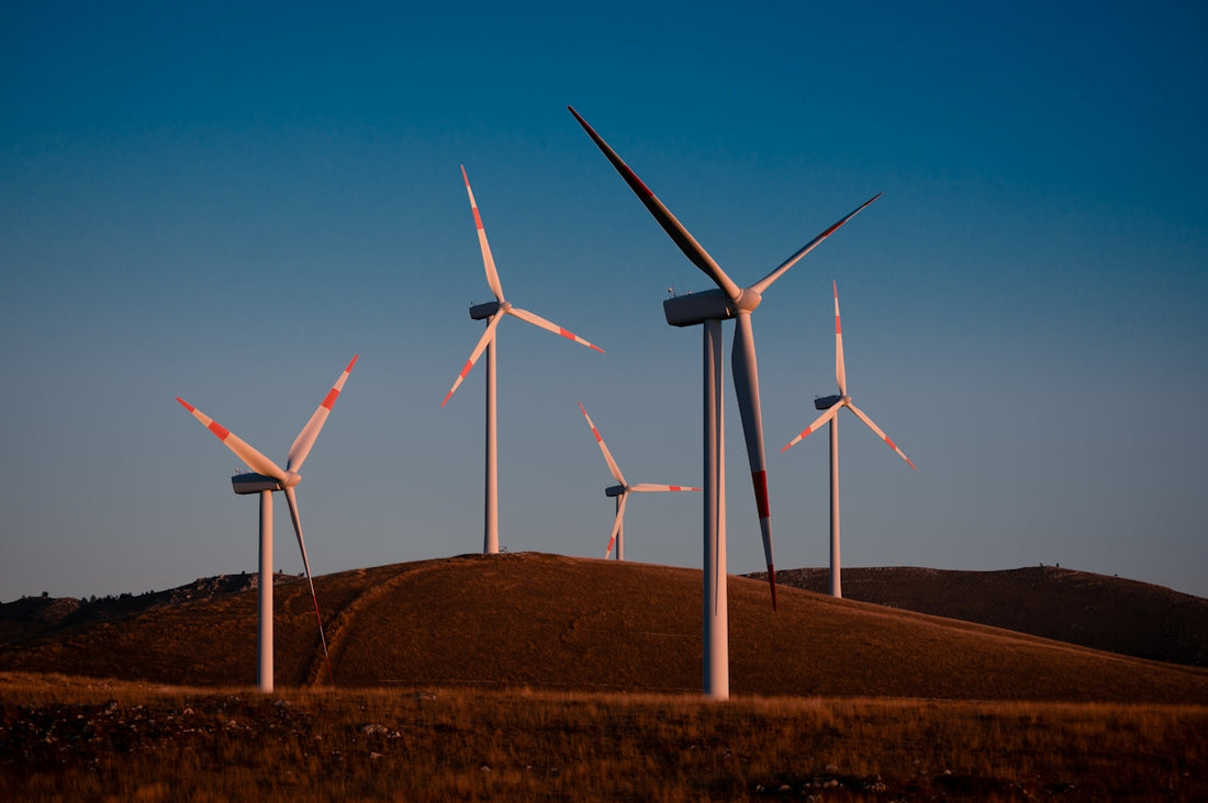 Wind turbines generate clean energy on a hill.