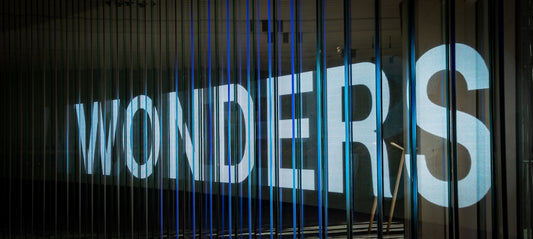 Large white letters spell out wonders behind bars.