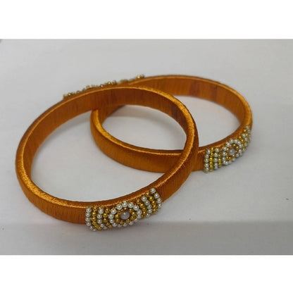 Two orange bangles with bead embellishments