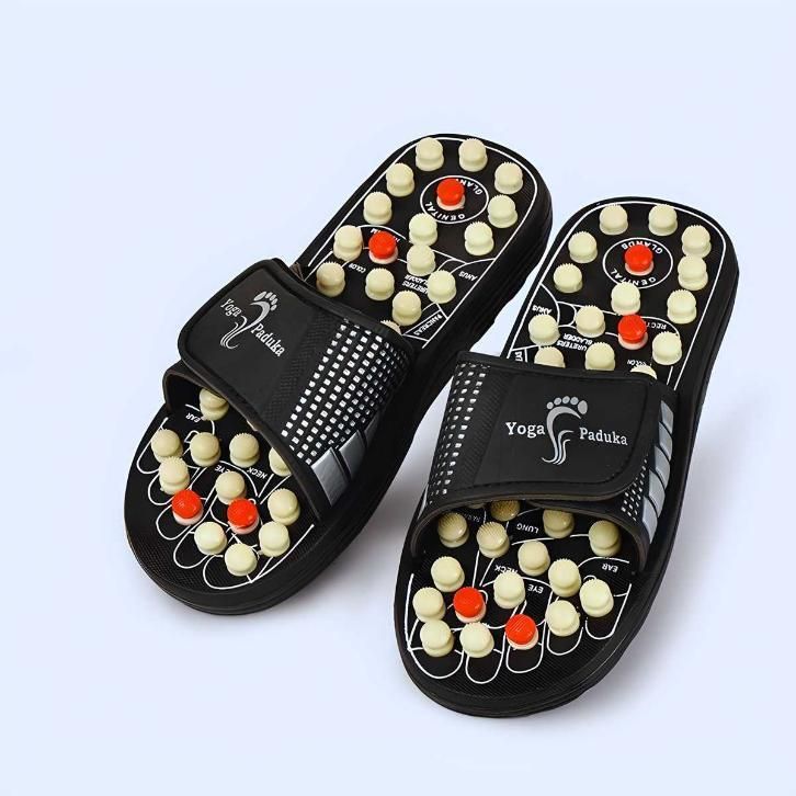 Pair of black yoga paduka slippers with acupressure nodes