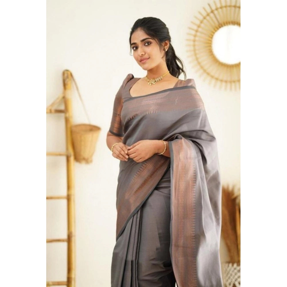 Woman wearing a gray litchi silk saree with a subtle pattern