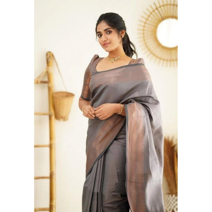 Woman wearing a gray litchi silk saree with a subtle pattern