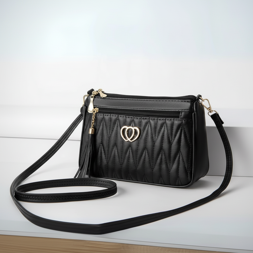 Black quilted handbag with a heart-shaped clasp