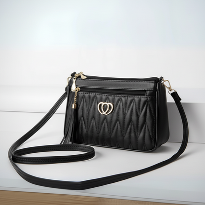 Black quilted handbag with a heart-shaped clasp